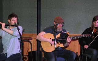 Dan, David and Emilie on stage at the Irish Cultural Society.