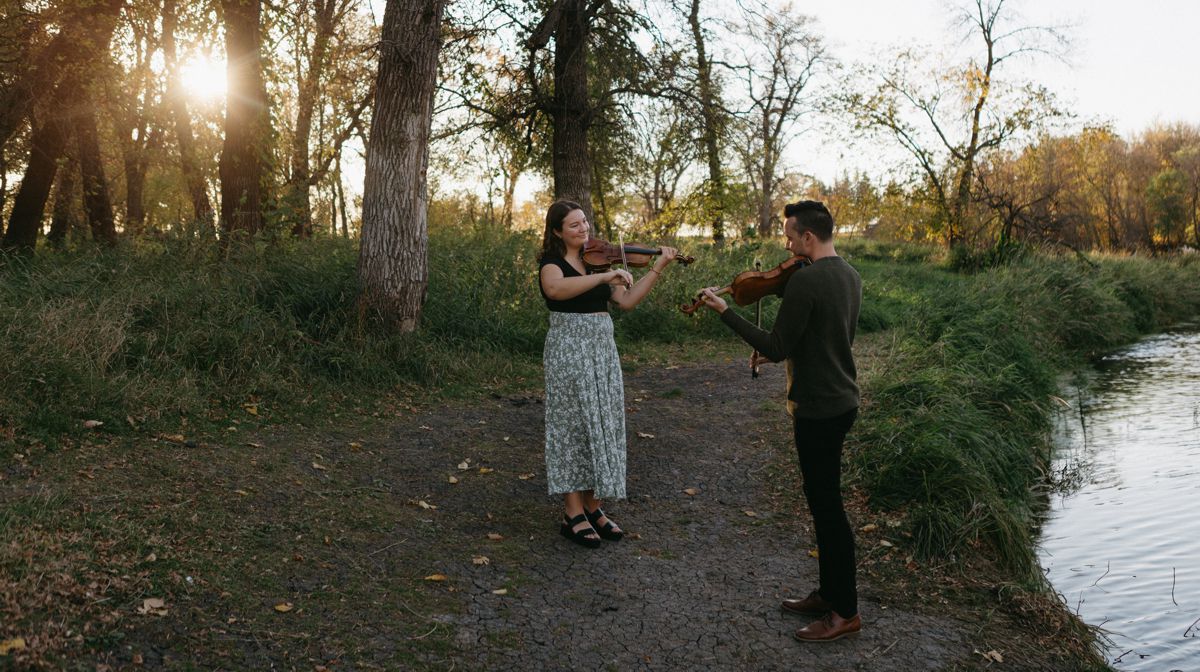 Jane & Kyle in woodland setting with water nearby.l